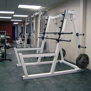 A white peg squat rack with a barbell and plates in a gym