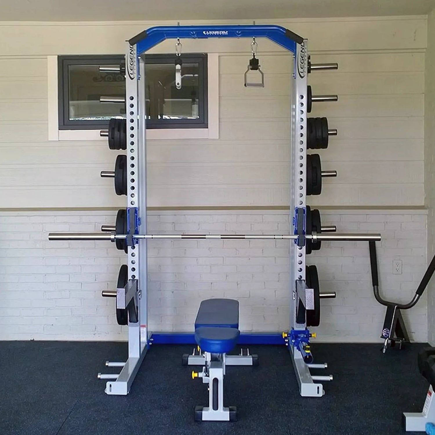 Gym weight rack with barbell against a white wall.