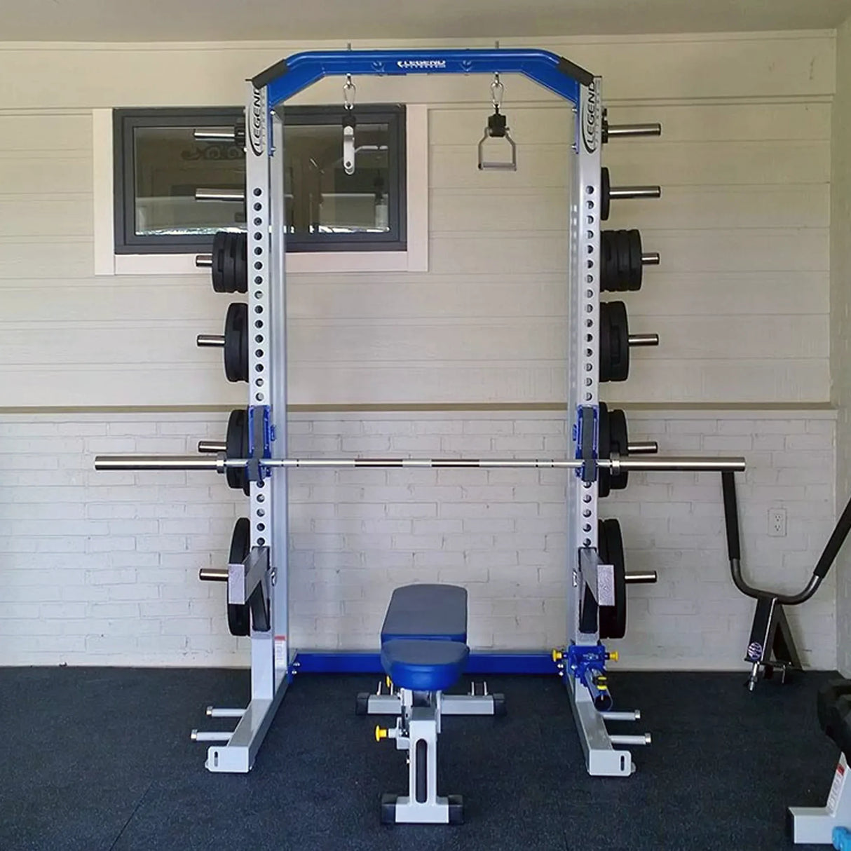 Gym weight rack with barbell against a white wall.
