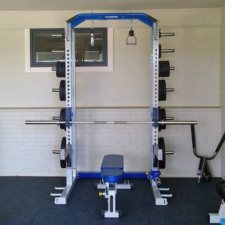 Gym weight rack with barbell against a white wall.