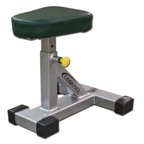 A silver framed fitness stool with a green pad on a white background