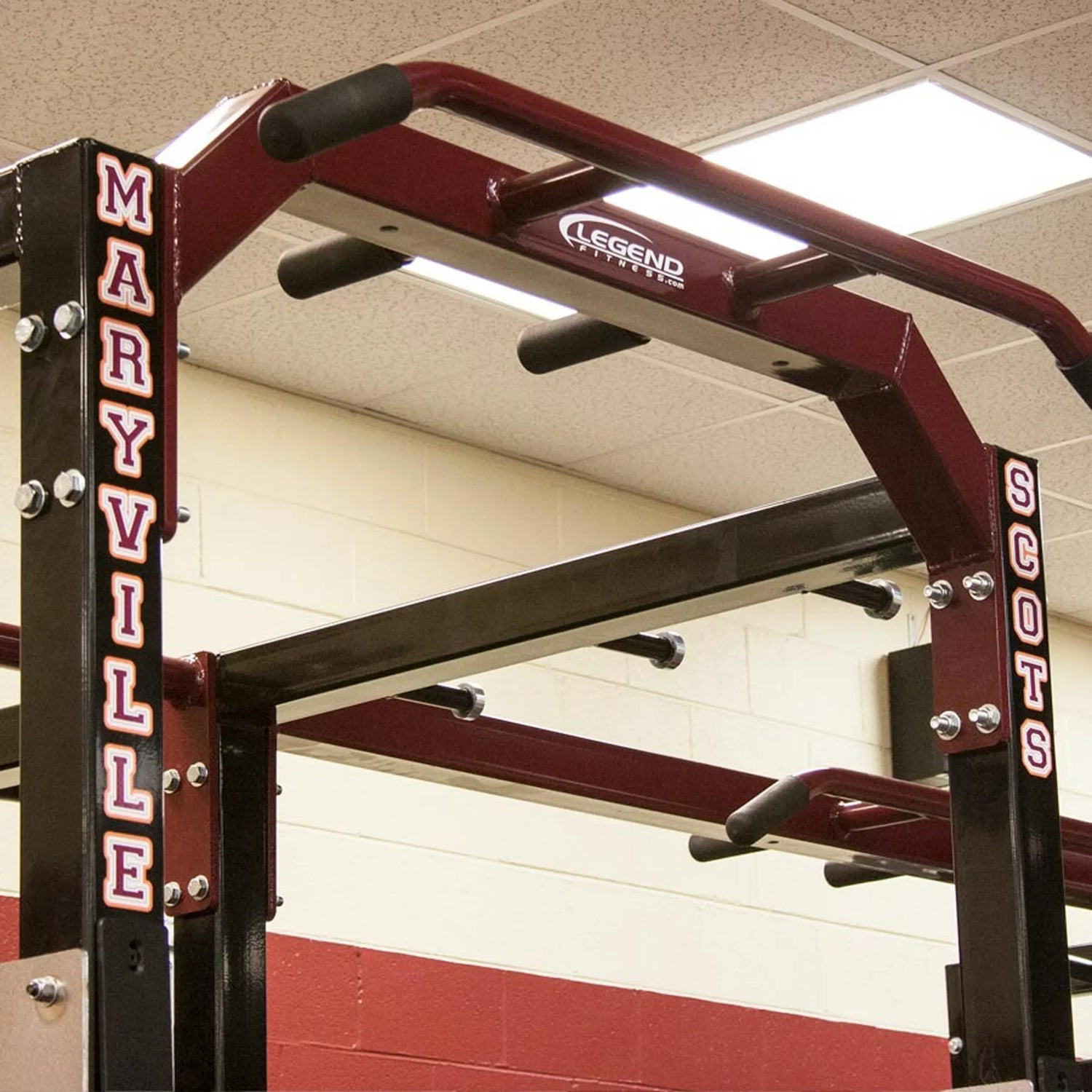 Gym equipment with 'Maryville' and 'Scots' branding on a red and white wall.