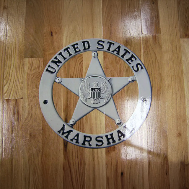 United States Marshal star badge on a wooden background