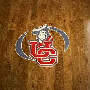 Logo with a stylized 'UC' on a wooden floor background