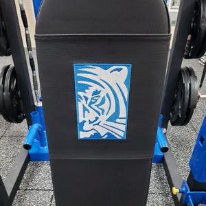 Black gym bench with a blue and white tiger logo embroidered on the pad