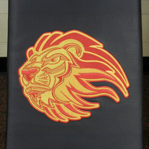 Embroidered lion logo on a black upholstered gym bench