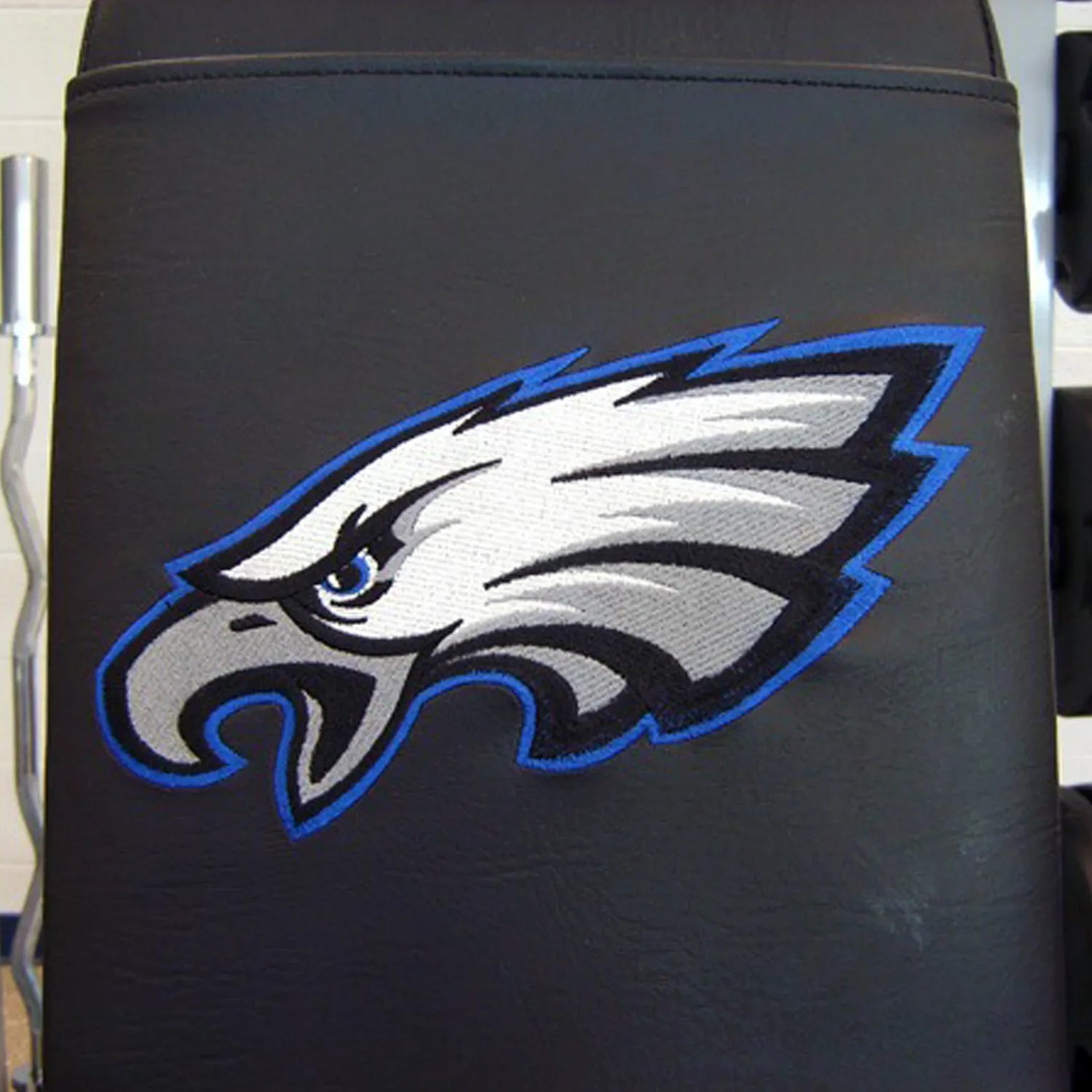 A black bench pad with an eagle logo embroidered on it