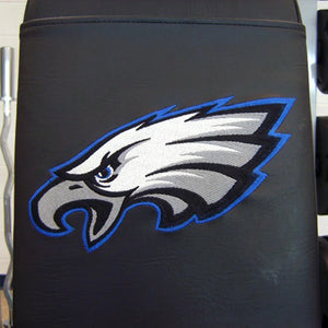 A black bench pad with an eagle logo embroidered on it