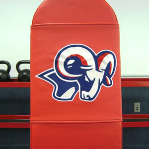 A red bench pad with a blue, white, and red ram head logo embroidered on it