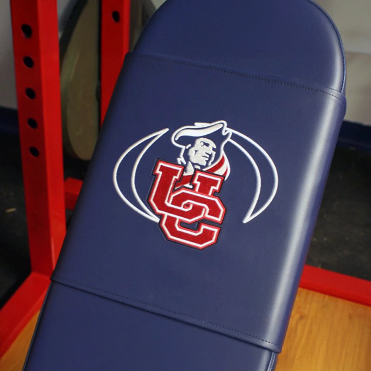 Blue gym bench with a logo on it, featuring red and white colors.