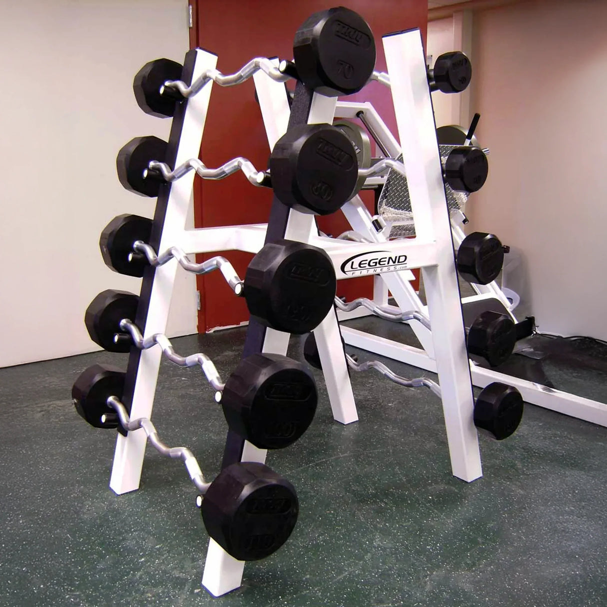 A white barbell storage rack with 10 barbells stored on it in a gym setting