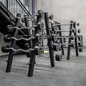 Two black barbell storage racks with barbells on them in a gym setting