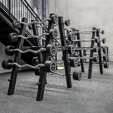 Two black barbell storage racks with barbells on them in a gym setting