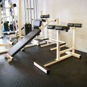 White and black fitness equipment in a gym setting.
