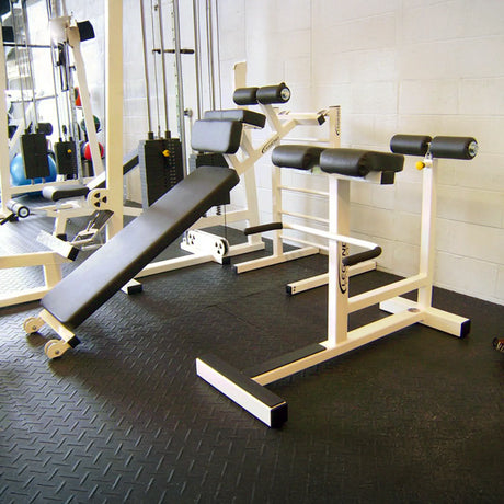 White and black fitness equipment in a gym setting.
