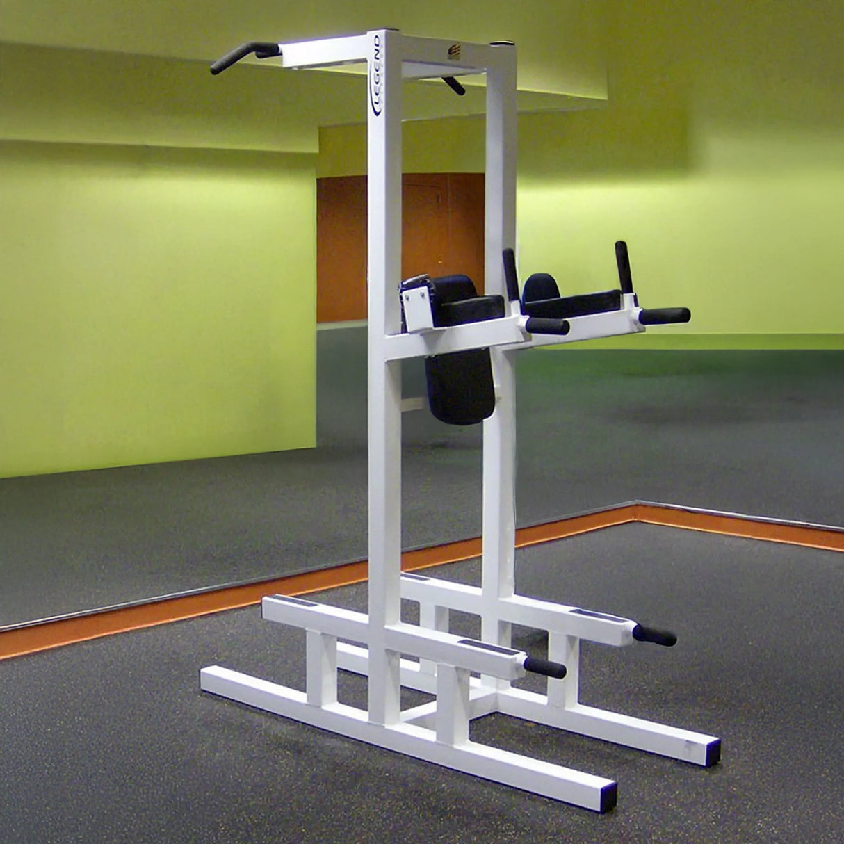 A white pull-up bar and core stand in an empty fitness center