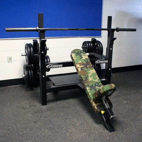 Gym bench with camo design and weights in a locker room setting