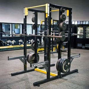Black Legend Fitness double-sided weightlifting power rack with weights in a gym setting