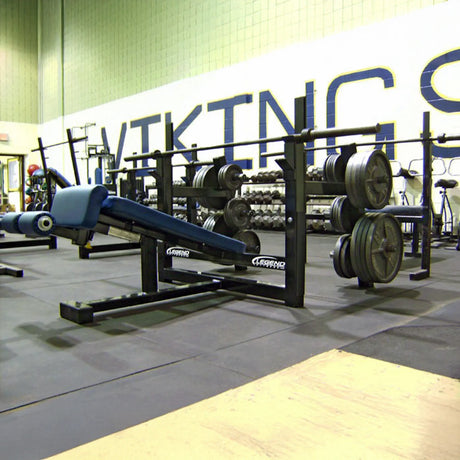 A black and blue Olympic decline bench press in a gym setting