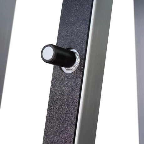 Close-up of a metal frame with a black knob on a white background