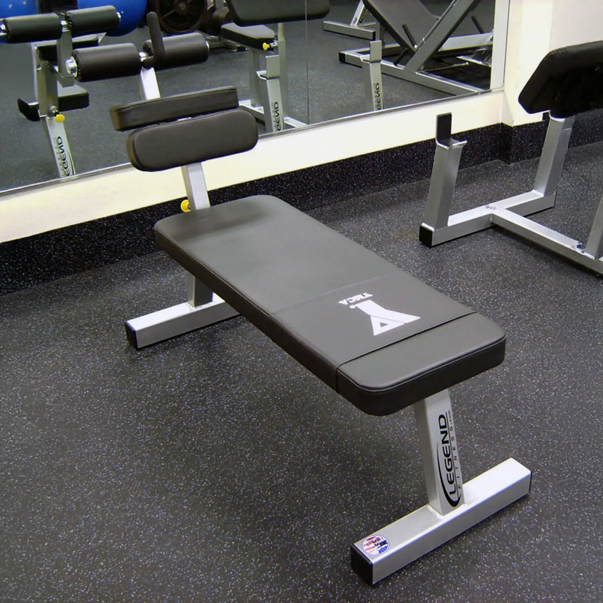 A black and gray ab bench in a gym setting