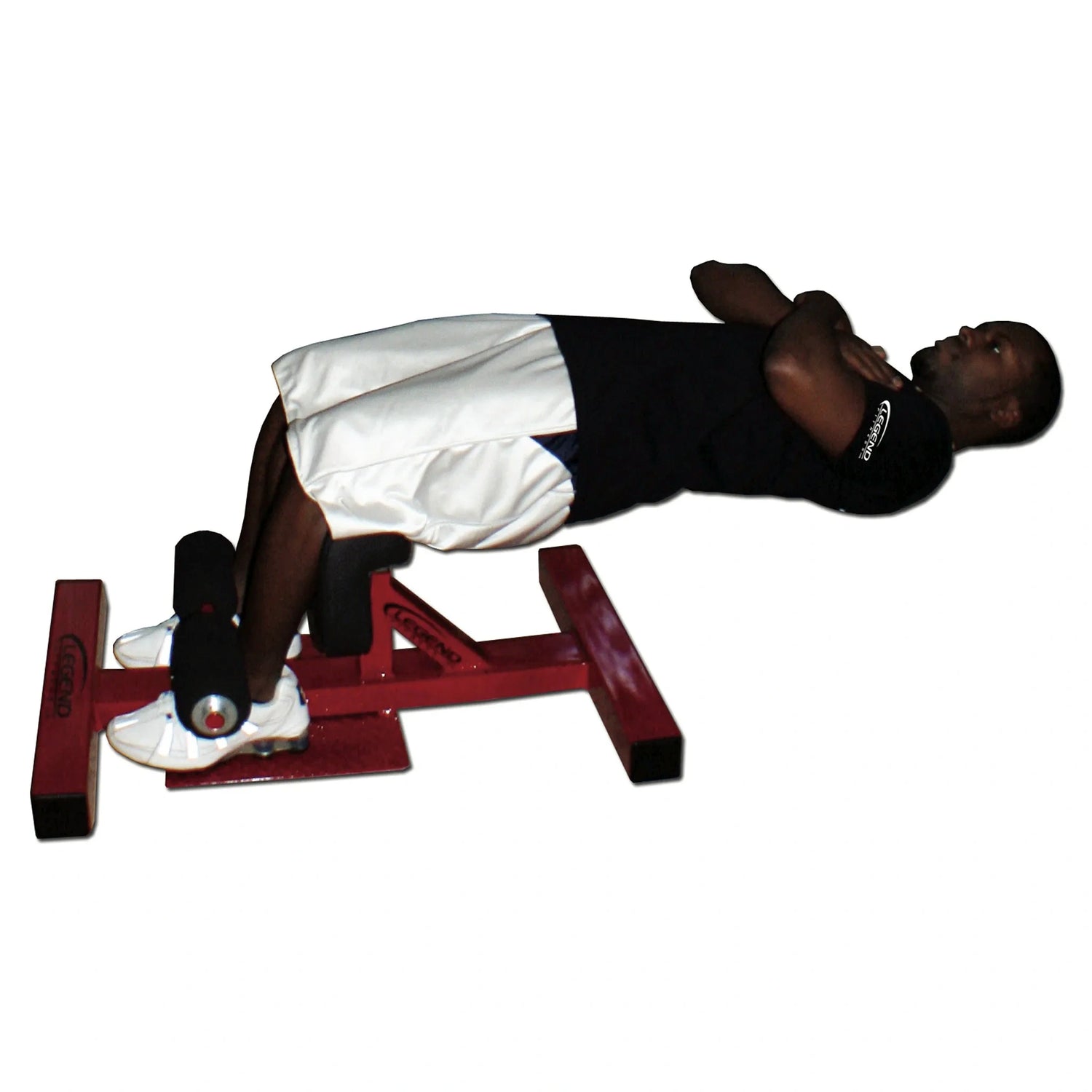 A man using a black and red Sissy Squat fitness machine on a white background
