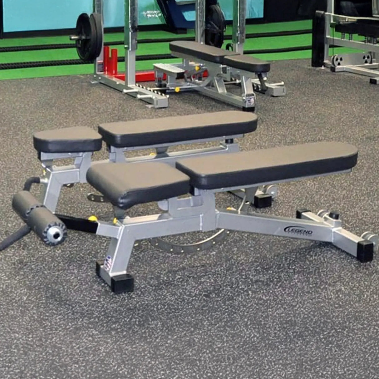 Adjustable weight bench in a gym setting with weights and equipment in the background.