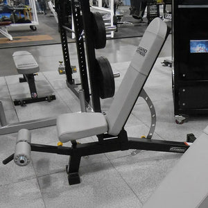 Gray and black weight bench on a gray floor in a gym setting