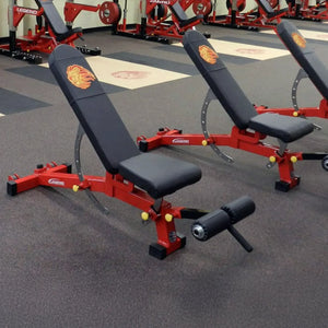 Red and black weight benches in a gym setting