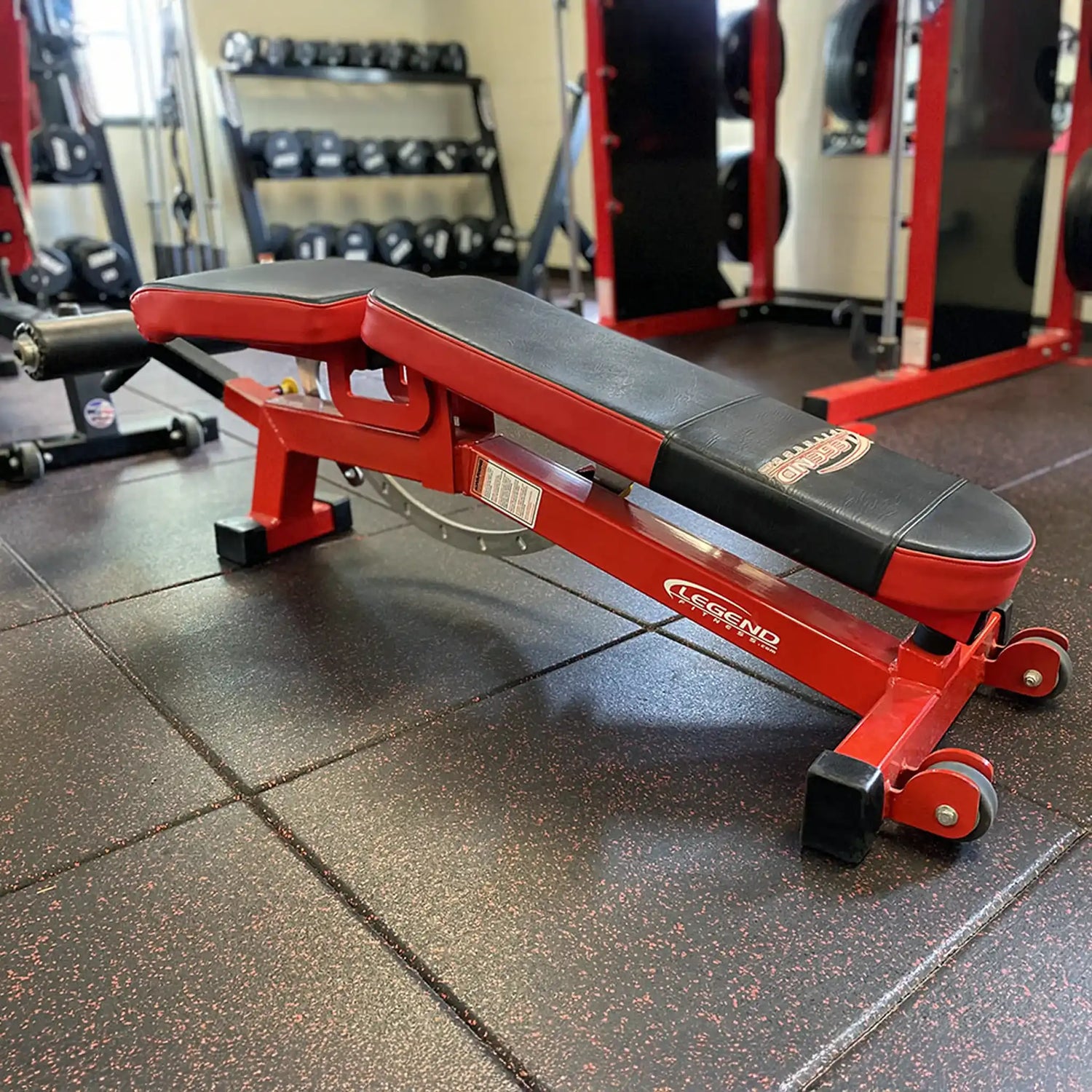 Red and black weight bench in a gym setting