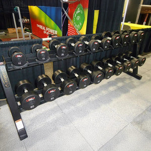 Set of dumbbells on a rack with colorful banners in the background