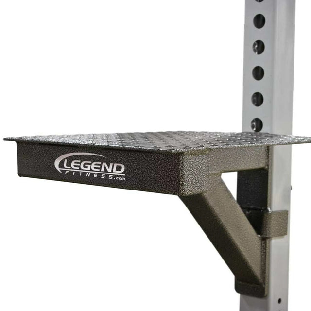 A black and silver metal step-up attachment mounted to a white metal vertical post with a white background