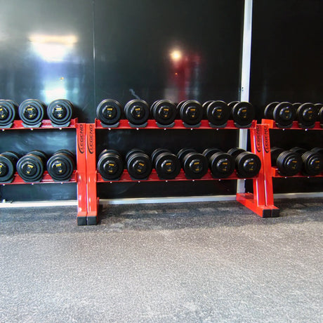 Row of dumbbells on multiple red racks in a gym setting