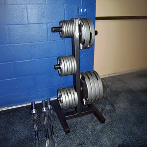 Set of weight plates on a stand in a gym setting