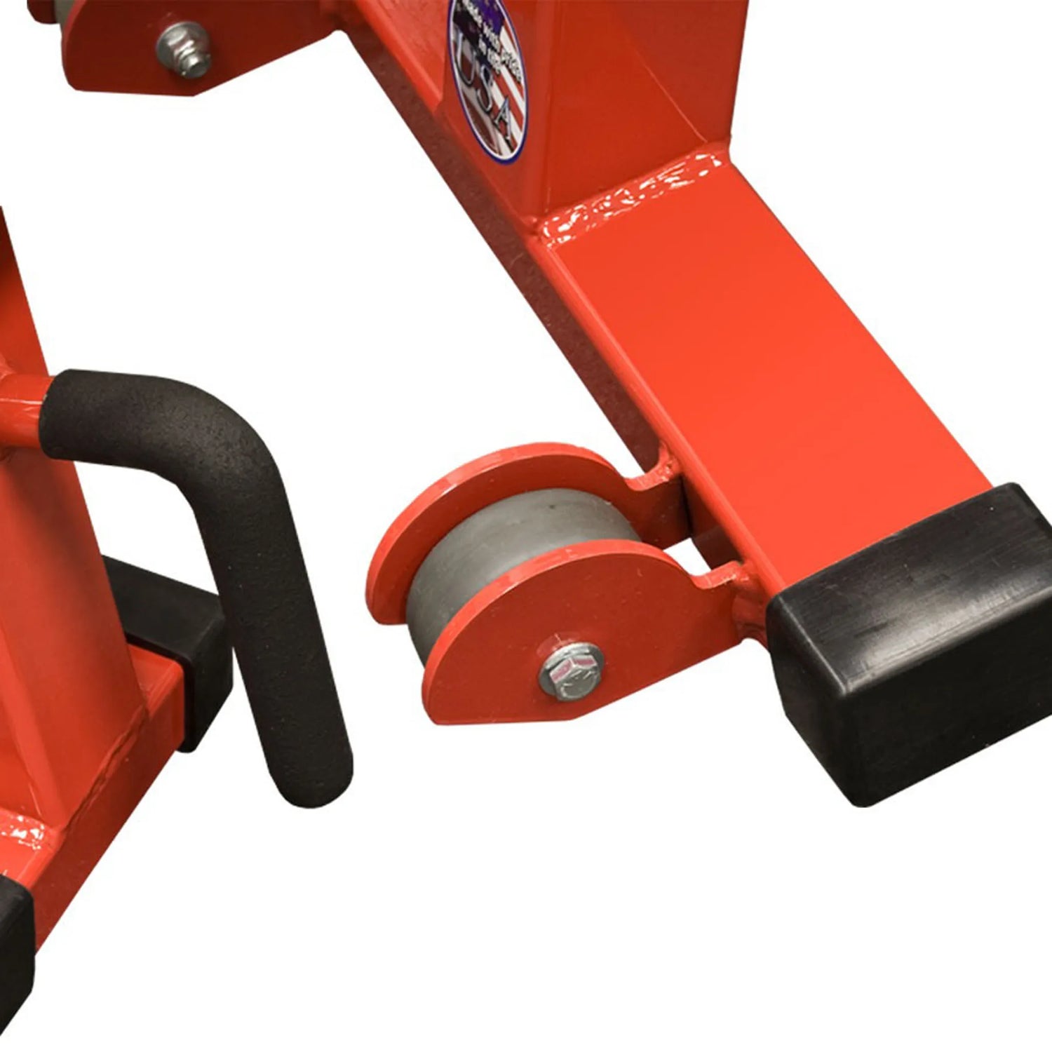 A closeup of a red wheel and black handle welded onto a weightlifting bench