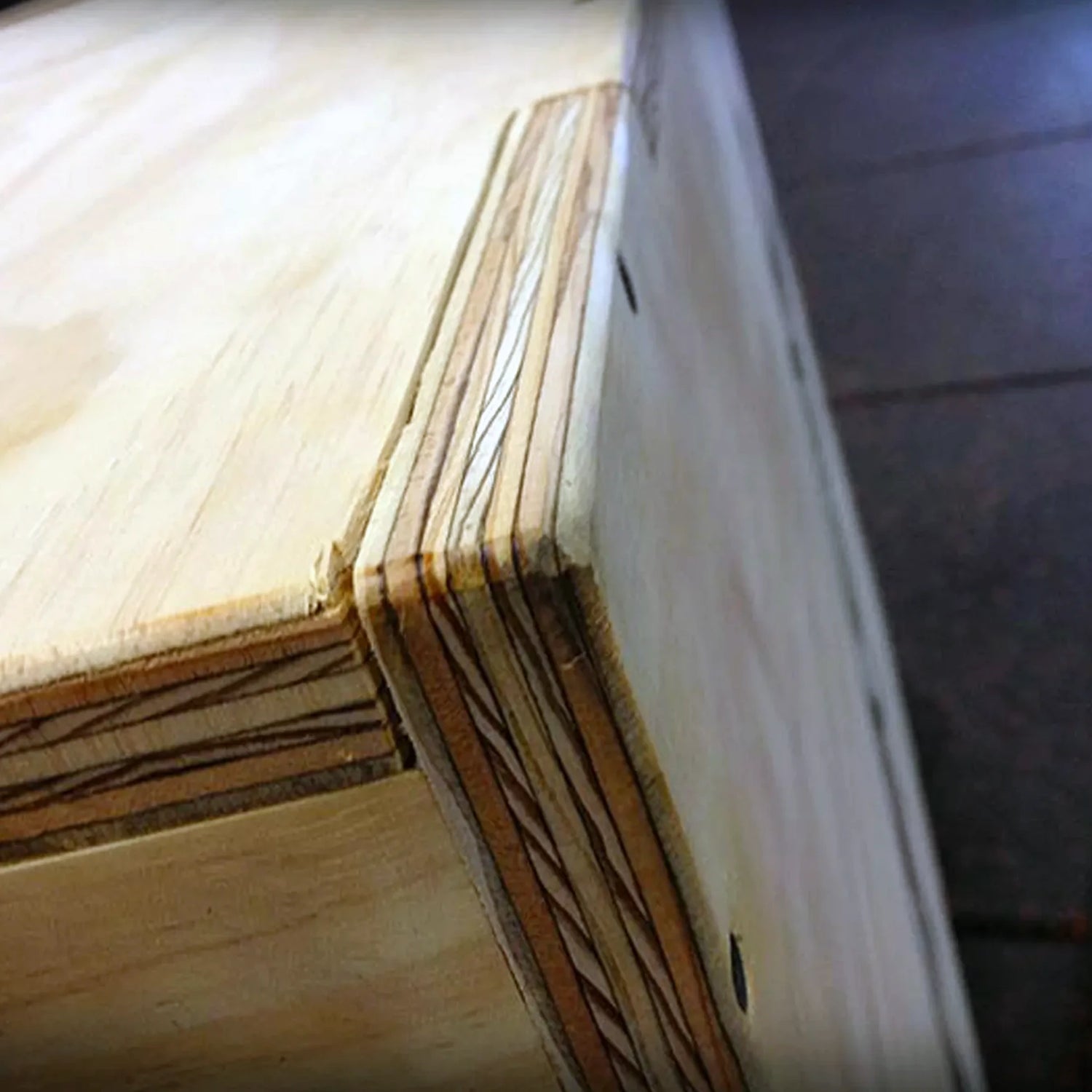 Close up image of a corner on a wooden plyometric box