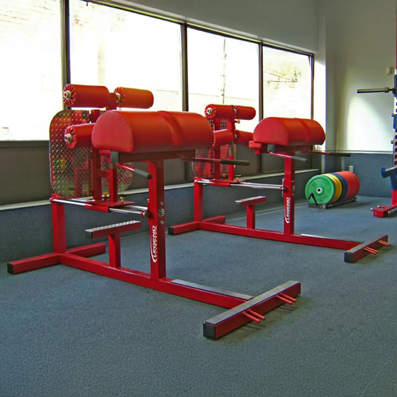 Two red glute ham developer fitness machines in a gym