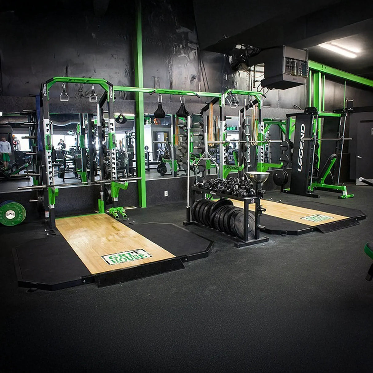 Gym interior with weightlifting equipment and Legend Fitness branding.