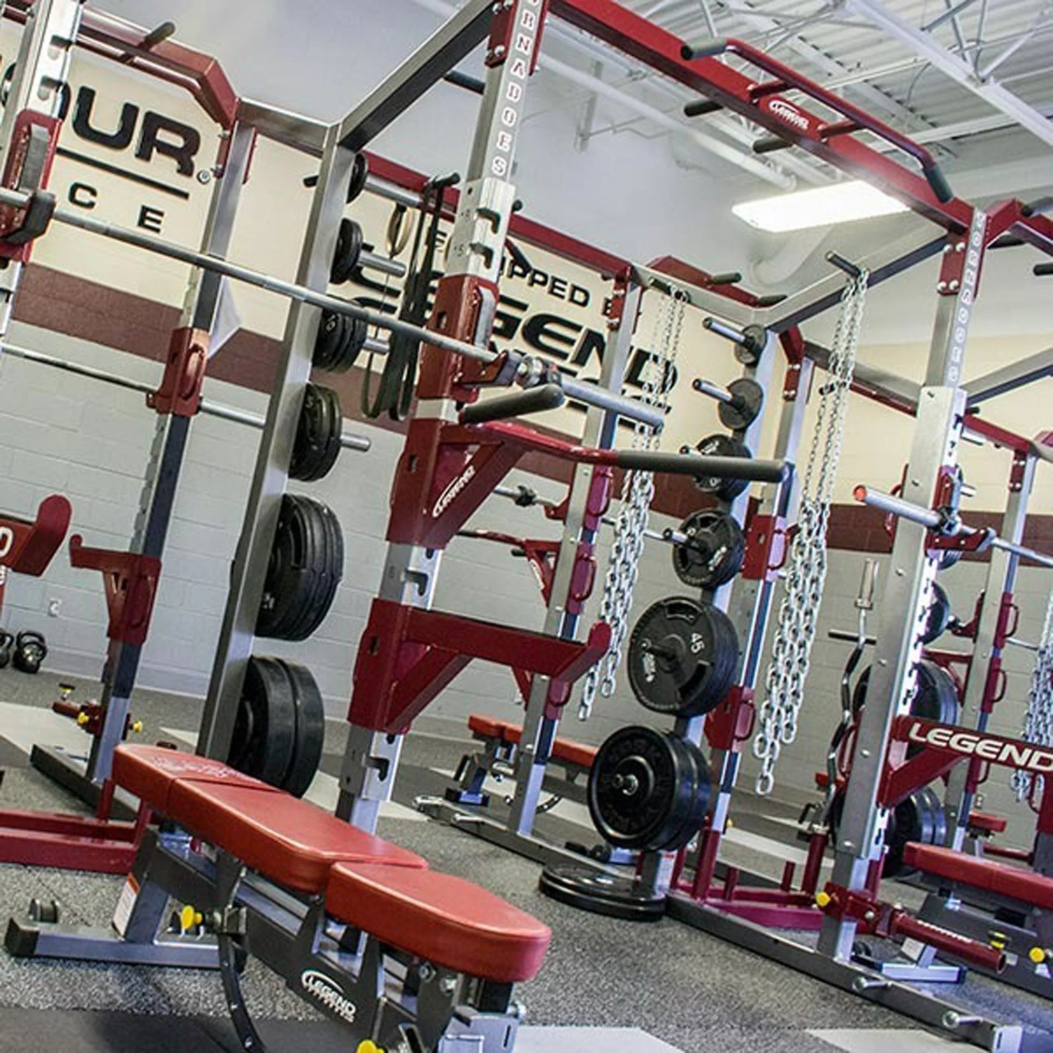 Gym equipment with Legend Fitness branding in a well-lit indoor setting.
