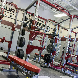 Gym equipment with Legend Fitness branding in a well-lit indoor setting.