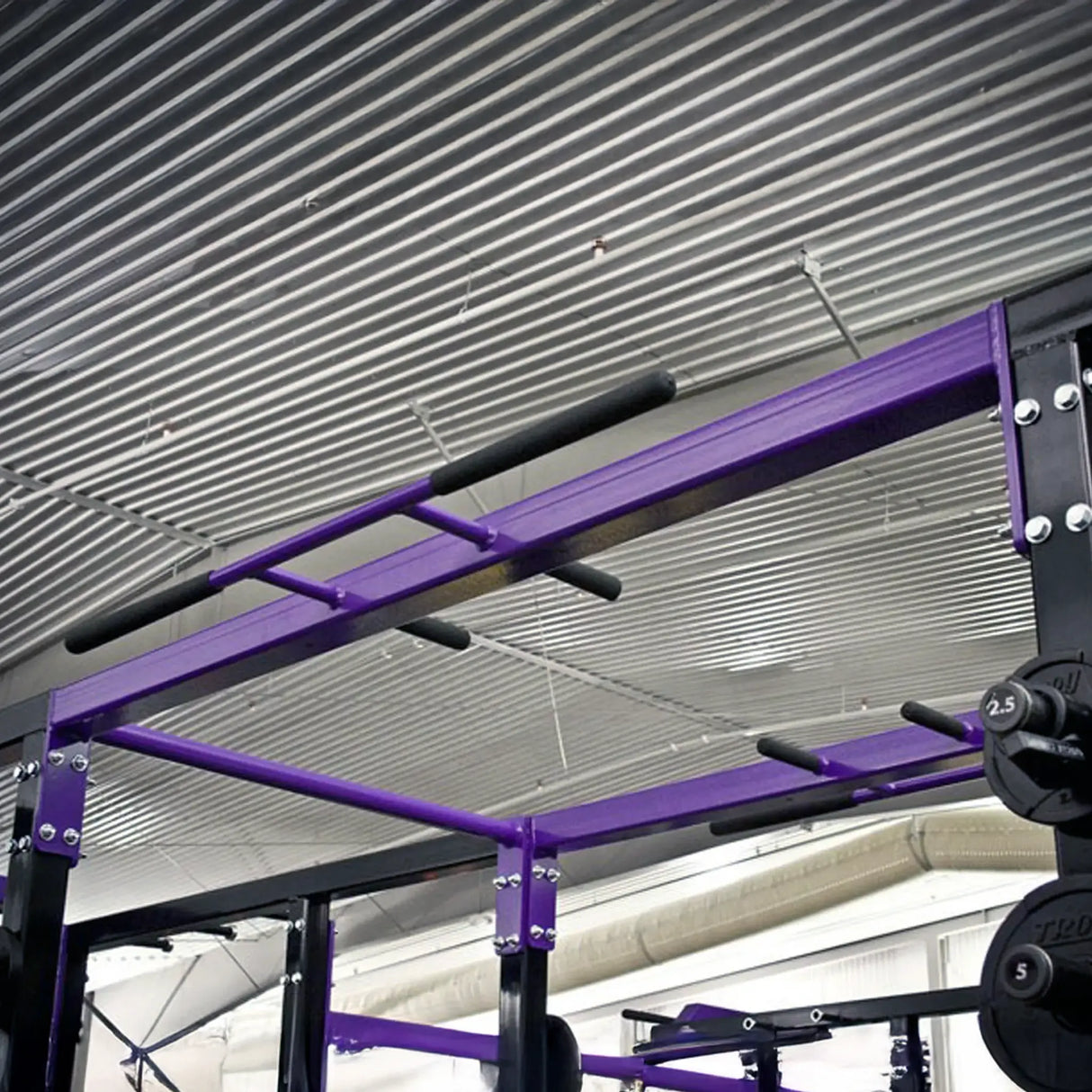 Purple pull-up bar crossmember spanning between two black squat racks