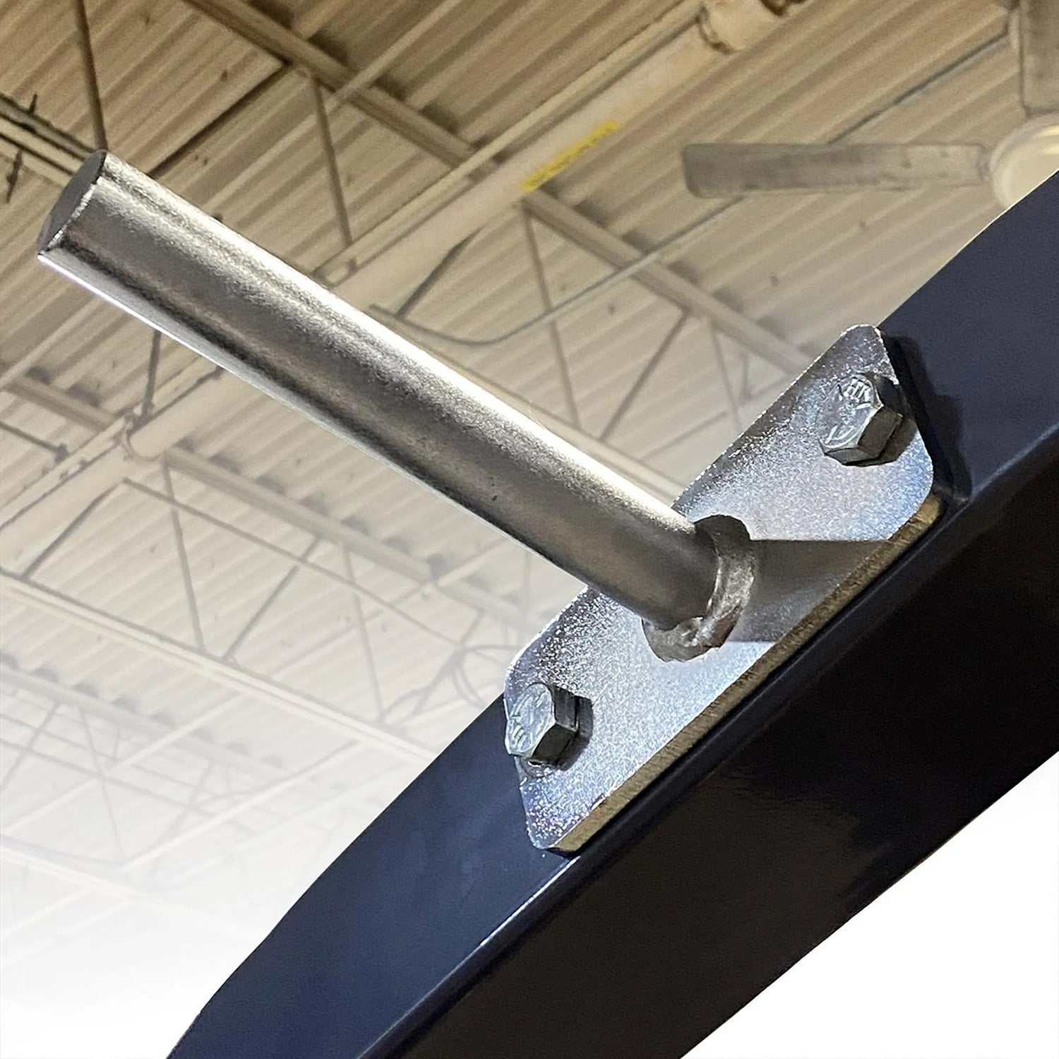 Gray metal beam with a chrome peg bolted on the side