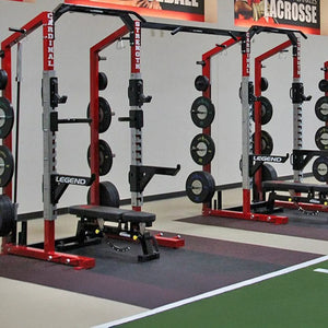 Gym equipment including weight racks and benches in a sports facility.
