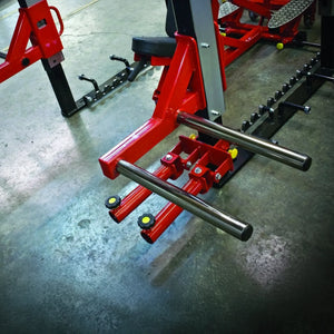 Red weightlifting bench with metal bar on a concrete floor