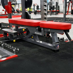 Red and gray weight bench in a gym setting