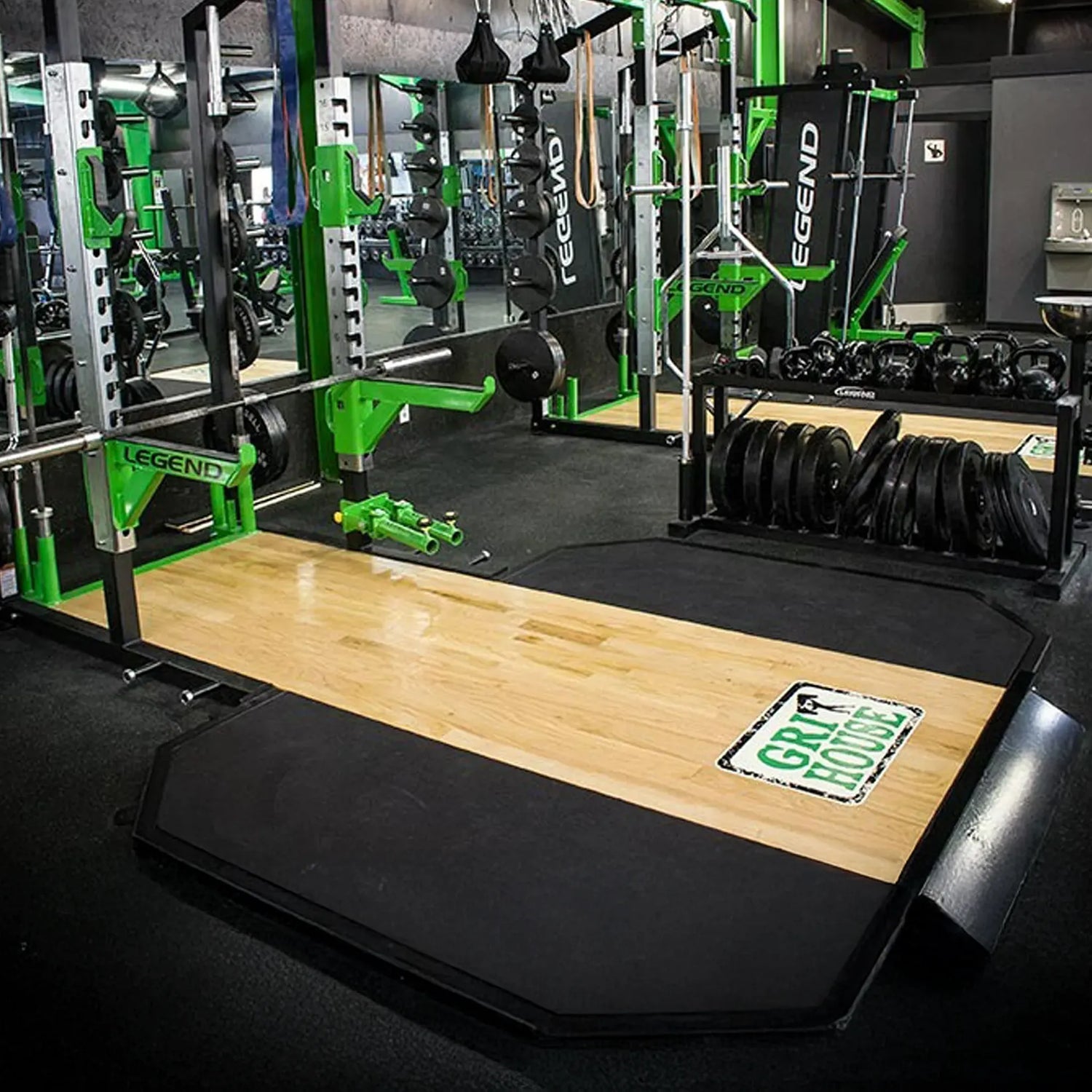 Gym interior with weightlifting equipment and Legend Fitness branding.