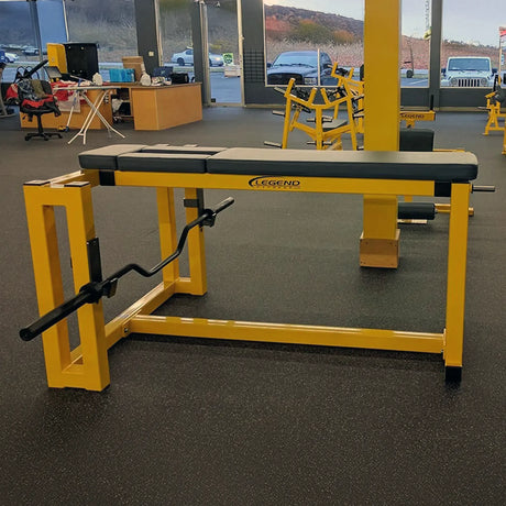 A yellow and black Legend Fitness seal row machine in a gym setting