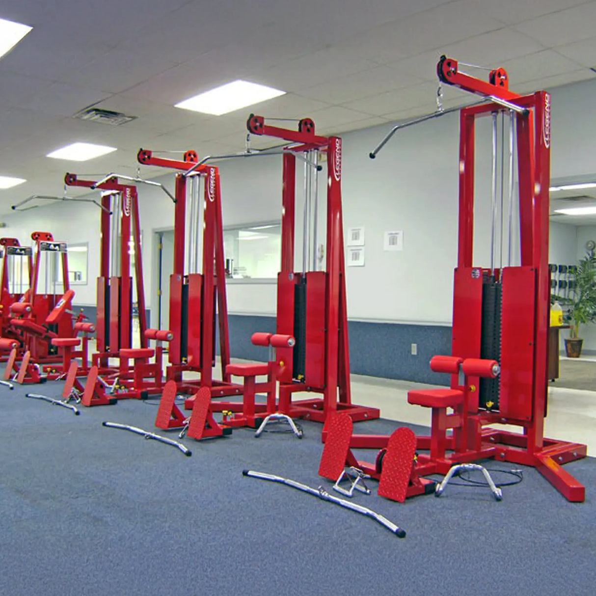 A row of lat pulldown floor row gym machines in a gym