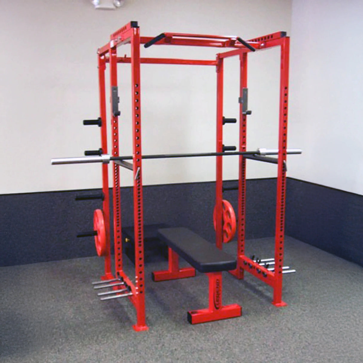 Red power rack with weight plates and bench in a gym setting
