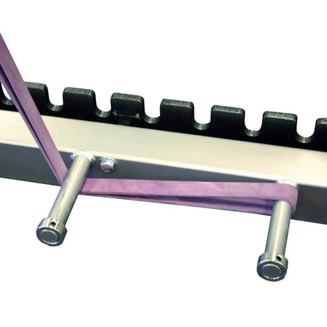 A horizontal metal beam with two metal prongs sticking out the side with a purple resistance band wrapped around the prongs